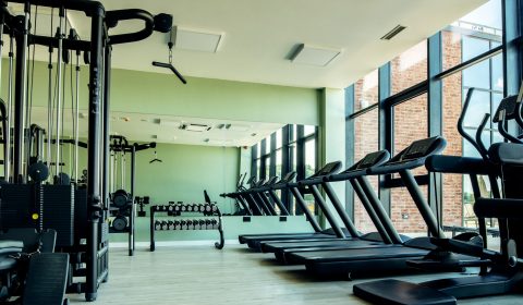 Gym with no people with exercises machines and equipment.